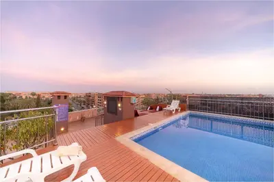 a balcony with a swimming pool on a building at Palm Menara Hotel Marrakech in Marrakech