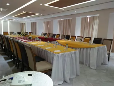 a conference room with a long table and chairs at Palm Menara Hotel Marrakech in Marrakech