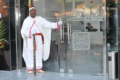a man dressed as a santa claus standing outside a building at Palm Menara Hotel Marrakech in Marrakech