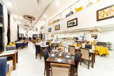 a restaurant with tables and chairs in a room at Palm Menara Hotel Marrakech in Marrakech