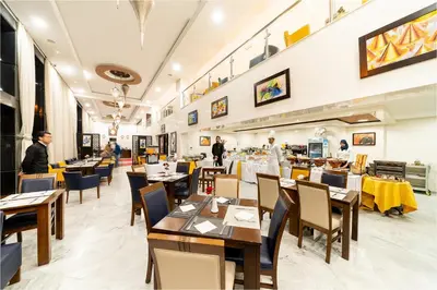a restaurant with tables and chairs and people in the background at Palm Menara Hotel Marrakech in Marrakech