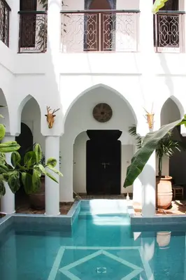a swimming pool in the middle of a building at Riad Al Tainam in Marrakech