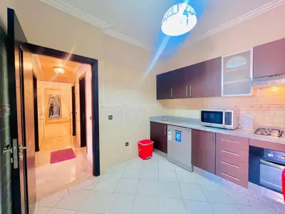 a large kitchen with a red trash can in it at Sabor Apartments Anas Majorelle in Marrakech