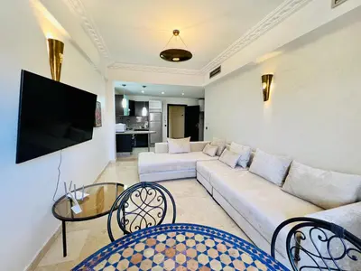 a living room with a couch and a tv at Sabor Apartments Anas Majorelle in Marrakech