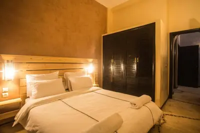 a bedroom with a large bed with white sheets and pillows at Les Résidences Du Domaine in Marrakech