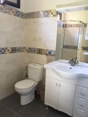 a bathroom with a toilet and a sink at Les Résidences Du Domaine in Marrakech
