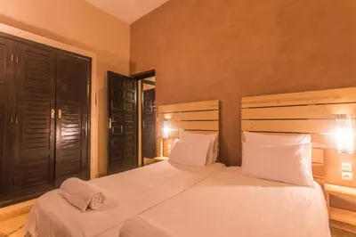 a bedroom with a large white bed with two pillows at Les Résidences Du Domaine in Marrakech