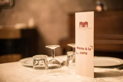 a table with a wine glass and a sign on it at Les Résidences Du Domaine in Marrakech