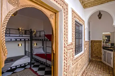 an archway leading into a room with two bunk beds at Hostel Amour d'auberge in Marrakech