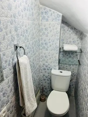 a bathroom with a white toilet and a towel at Hostel Amour d'auberge in Marrakech