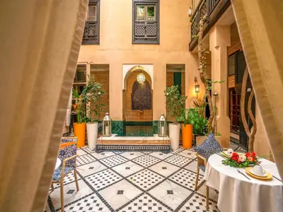 a view of a courtyard with a table and chairs at Riad Ines Home in Marrakech