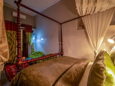 a bedroom with a bed with a canopy at Riad Ines Home in Marrakech