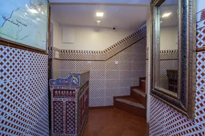 a hallway with a staircase in a room with a mirror at Hotel Zitoune in Marrakech