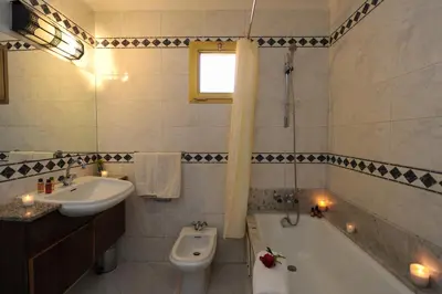 a bathroom with a sink and a tub and a toilet at Appart-Hotel Amina Resort & Spa in Marrakech