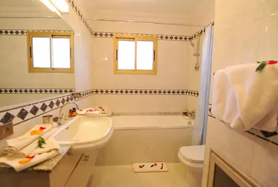 a bathroom with a sink and a tub and a toilet at Appart-Hotel Amina Resort & Spa in Marrakech