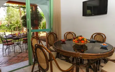 a dining room with a table with a bowl of fruit at In Club Palmeraie Resorts in Marrakech