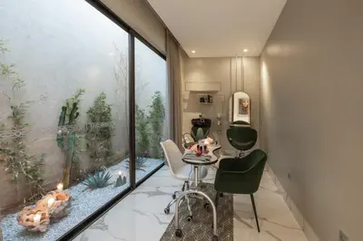 a room with a table and chairs and a large window at Sirayane Boutique Hotel & Spa Marrakech in Marrakech