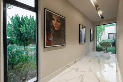 a hallway with large windows and a painting on the wall at Sirayane Boutique Hotel & Spa Marrakech in Marrakech