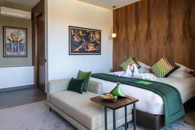 a hotel room with a large bed and a couch at Sirayane Boutique Hotel & Spa Marrakech in Marrakech