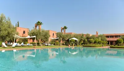 a large swimming pool in front of a building at Les Jardins De Zyriab in Aït Hamid