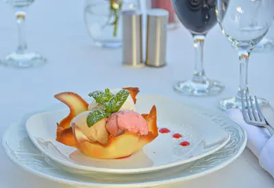 a white plate with a dessert on a table at Les Jardins De Zyriab in Aït Hamid