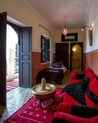 a living room with a couch and a bed at Riad Ciel d'Orient in Marrakech