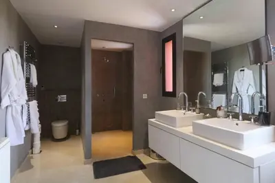 a bathroom with two sinks and a large mirror at Villa Riad Al Maaden in Marrakech