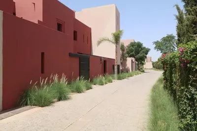 an empty street in front of a red building at Villa Riad Al Maaden in Marrakech