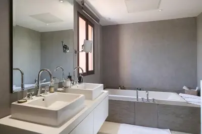 a bathroom with two sinks and a bath tub at Villa Riad Al Maaden in Marrakech