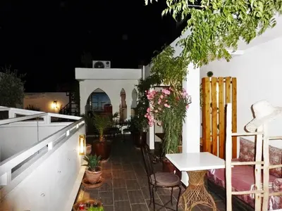 a patio with a table and chairs and plants at Riad Safina in Marrakech