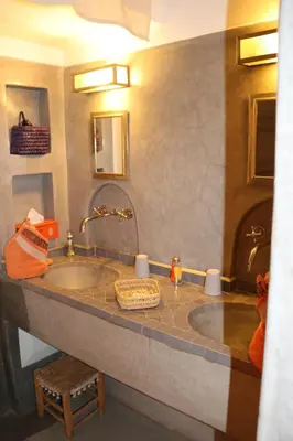 a bathroom with a large sink in a room at Dar Andamaure in Marrakech