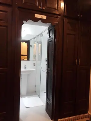 a bathroom with a glass shower and a sink at Les Rêves De Marrakech in Marrakech