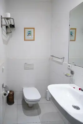 a white bathroom with a toilet and a sink at Les Rêves De Marrakech in Marrakech