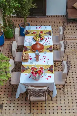 a table with a plate of food on it at Les Rêves De Marrakech in Marrakech