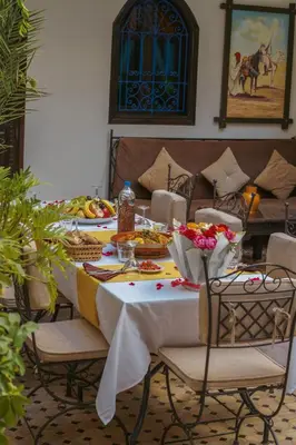a table with plates of food on it at Les Rêves De Marrakech in Marrakech