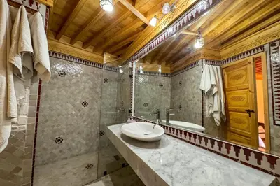 a bathroom with a sink and a shower and a tub at Riad Dar Moulay Ali in Marrakech