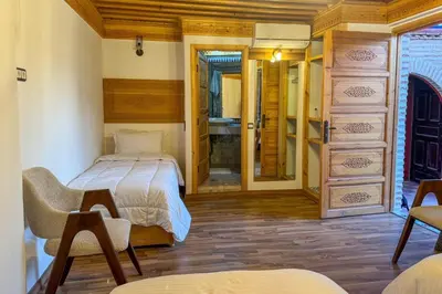 a bedroom with a bed and a bathroom at Riad Dar Moulay Ali in Marrakech