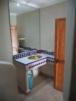 a bathroom with a sink and a mirror at Riad Dar Moulay Ali in Marrakech