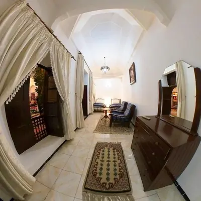 a living room with a couch and a table at Riad Dar Moulay Ali in Marrakech