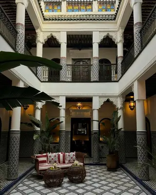 a lobby with a couch in the middle of a building at Riad Yakimour in Marrakech