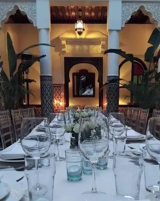 a long table with wine glasses on it at Riad Yakimour in Marrakech
