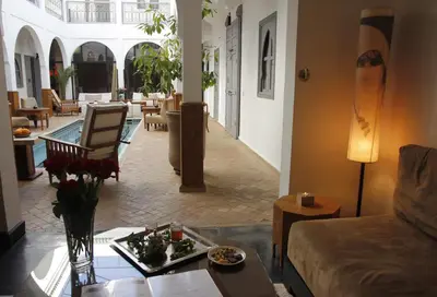a living room with a couch and a table at Riad Utopia Suites And Spa in Marrakech