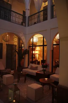a living room with a couch and tables at Riad Utopia Suites And Spa in Marrakech