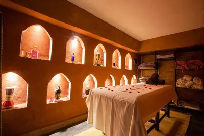a room with a table with wine bottles on it at Riad Ayadina & SPA in Marrakech