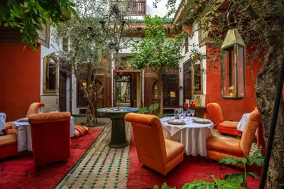 a patio with a table and chairs in a building at Riad Ayadina & SPA in Marrakech