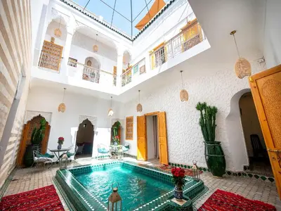 a large room with a swimming pool in a building at Riad La Croix Berbere in Marrakech