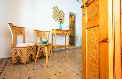 a room with two chairs and a table at Riad La Croix Berbere in Marrakech