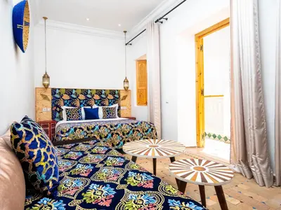 a living room with a couch and a table at Riad La Croix Berbere in Marrakech