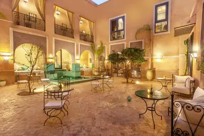 a large room with tables and chairs in a building at Le Medina Privilège Riad & Spa in Marrakech