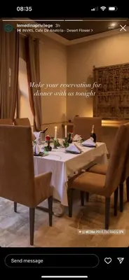a dining room with a table with a candle and chairs at Le Medina Privilège Riad & Spa in Marrakech